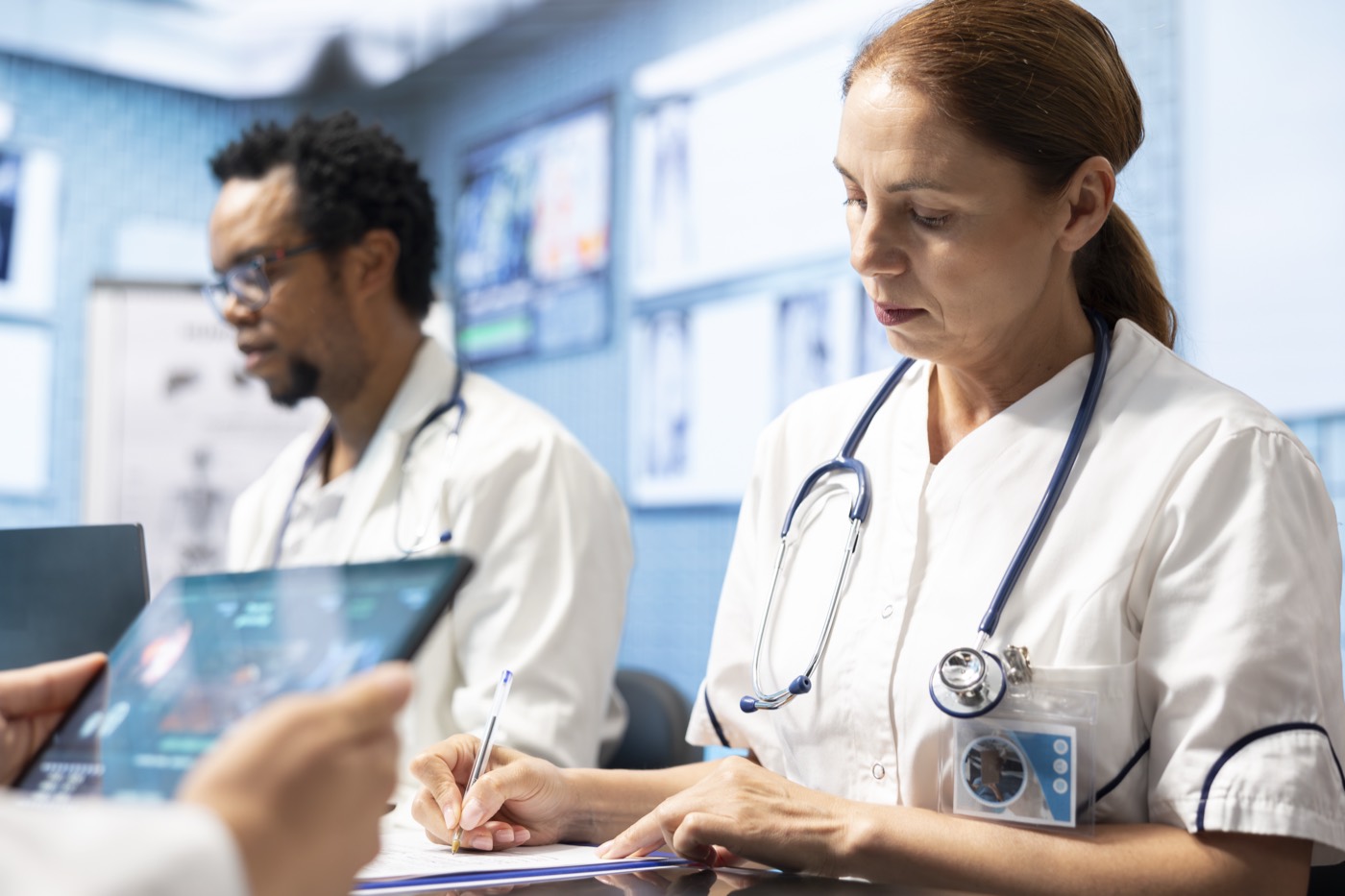 Clinicians reviewing records together in a clinical setting